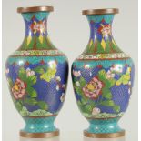 A PAIR OF CHINESE BLUE GROUND CLOISONNE VASES, with floral decoration, 16cm high.