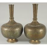 A PAIR OF INDIAN ENGRAVED AND CHASED BRASS VASES, 28cm high.