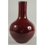 A LARGE CHINESE OX BLOOD GLAZE PORCELAIN VASE, the base with six-character mark, 33.5cm high.