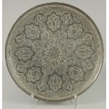 A LARGE QAJAR EMBOSSED AND CHASED WHITE METAL DISH, 48.5cm diameter.