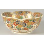 A JAPANESE SATSUMA PETAL-FORM BOWL, decorated with multiple flower heads and gilt highlights, the