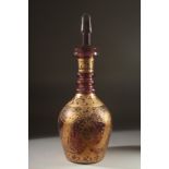 A LARGE BOHEMIAN GLASS BOTTLE AND STOPPER, the body with decorative gilded motifs, 48cm high.