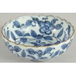 A CHINESE BLUE AND WHITE PORCELAIN BOWL, with ribbed exterior and petal form rim, decorated with