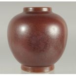 A CHINESE MOTTLED RED GLAZE JAR, character mark to base, 15.5cm high.