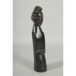 AN AFRICAN CARVED WOOD STANDING FIGURE, 33cm high.