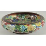 A LARGE CHINESE CLOISONNE BOWL, decorated all over with various colourful flower heads, the base
