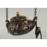 A CHINESE GILDED BRONZE HANGING CENSER AND COVER, with hanging monkey figure, 11.5cm wide.
