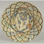 A 16TH-17TH CENTURY PERSIAN SAFAVID KUBACHI GLAZED POTTERY DISH, painted with central floral