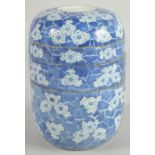A CHINESE BLUE AND WHITE PORCELAIN STACKING FOOD CONTAINER, comprising four sections, painted with