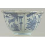 AN 18TH CENTURY NANKING CARGO BLUE AND WHITE PORCELAIN BOWL, decorated with panels of flora and