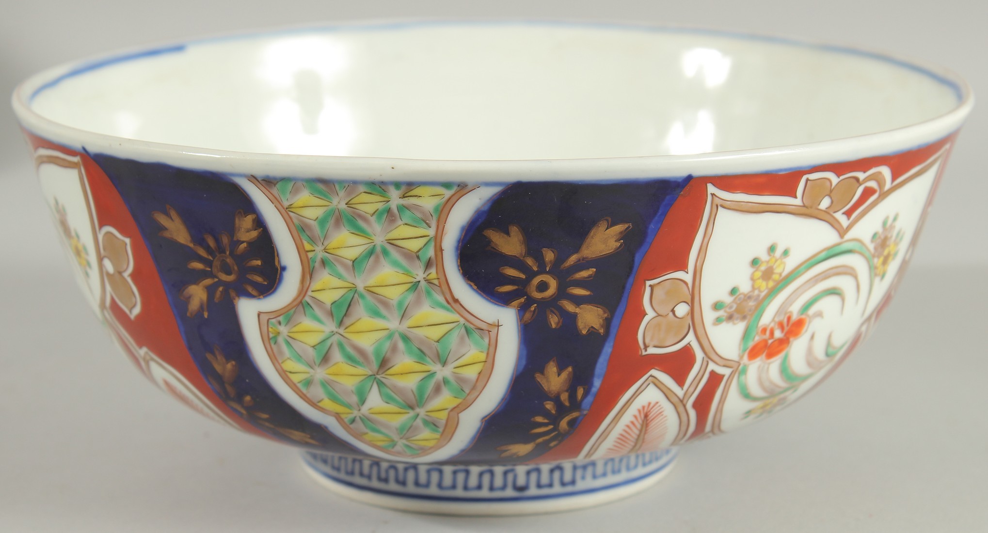 A LARGE JAPANESE IMARI PORCELAIN BOWL, painted with various foliate motifs and gilt highlights,