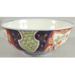 A LARGE JAPANESE IMARI PORCELAIN BOWL, painted with various foliate motifs and gilt highlights,