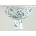 A CHINESE BLUE AND WHITE PORCELAIN STEM BOWL, decorated with phoenix and flora, 17cm diameter.