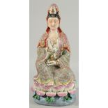 A CHINESE FAMILLE ROSE PORCELAIN GUANYIN FIGURE, seated upon a lotus base, impressed mark beneath,