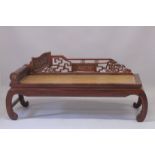 A LARGE CHINESE LONG DAY BED with rolling head rest. 6ft long.