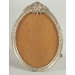 A RUSSIAN SILVER OVAL EASEL PHOTOGRAPH FRAME. 5ins x 3.5ins.