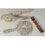 A FOUR PIECE SILVER MIRROR AND BRUSH SET.