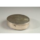 A GEORGE III WHITE METAL OVAL SNUFF BOX, the lid with a crest. 2.25ins x 2.75ins.