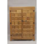 ROBERT "MOUSEMAN" THOMPSON. AN OAK TWO DOOR WARDROBE with a pair of panelled doors, panelled ends,