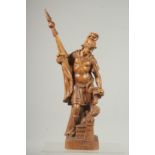 A GOOD 19TH CNTURY CARVED WOOD ROMAN SOLDIER holding a coloured flag and standing beside a fire.