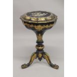 A VICTORIAN PAPIER MACHE TEA POUY ON A TRIPOD BASE, inlaid with mother of pearl and decorated in