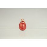 A 14CT GOLD RUSSIAN RED ENAMEL EGG PENDANT.