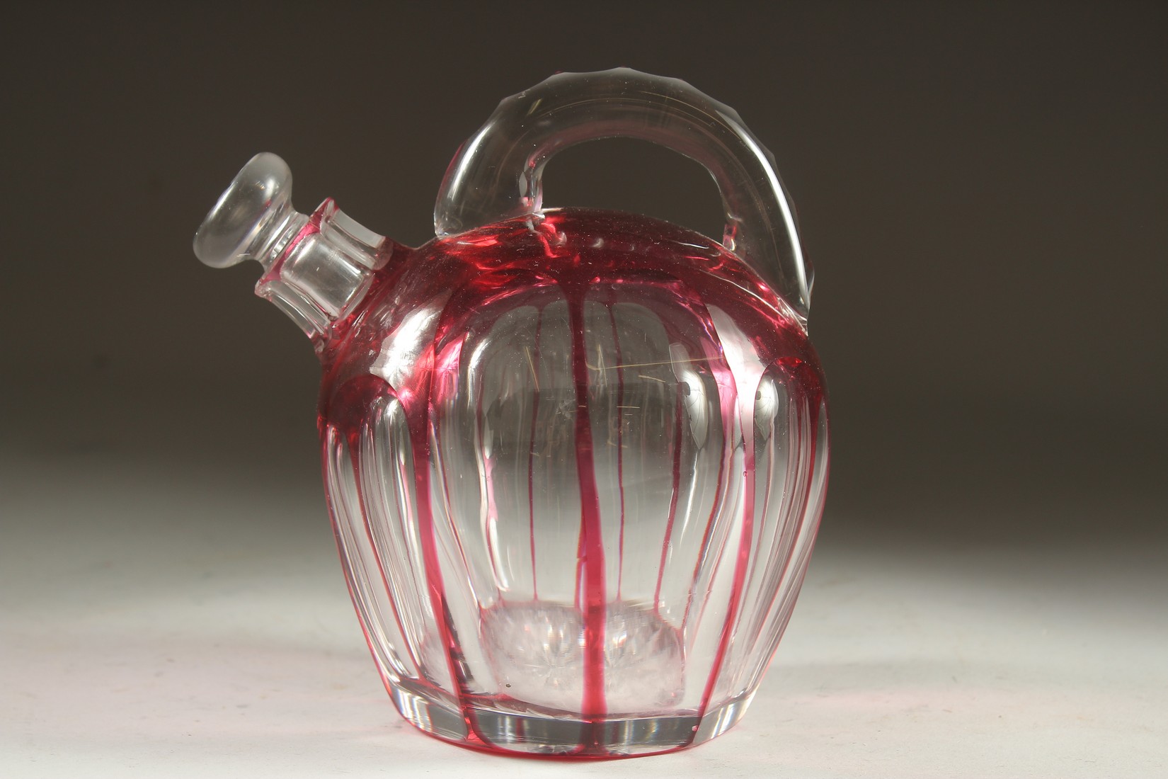 A SLICE CUT RUBY TINTED GLASS EWER with stopper. 7ins high. - Image 3 of 5