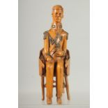 A RARE 19TH CENTURY CARVED BOXWOOD FIGURE OF NAPOLEON sitting in a chair. 9inshigh.