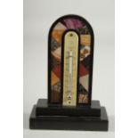 A DERBYSHIR ASHFORD THERMOMETER with coloured specimen marbles, black frame and thermometer. 5.75ins