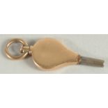 A SMALL 9CT GOLD WATCH KEY with metal tip.