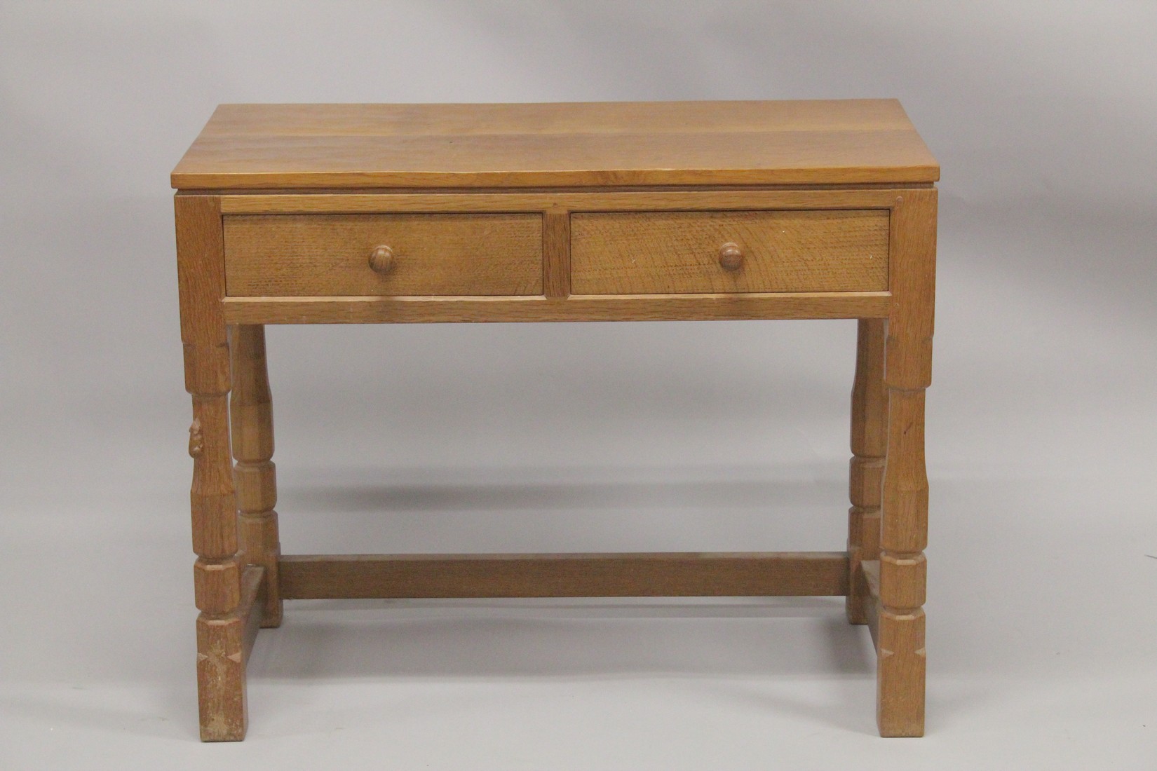 ROBERT "MOUSEMAN" THOMPSON. AN OAK SIDE TABLE with an adzed rectangular top, two frieze drawers with
