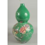 A CHINESE GREEN PORCELAIN DOUBLE GOURD VASE decorated with flowers. Six-character mark in blue.