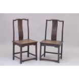 A PAIR OF CHINESE HARDWOOD CHAIRS with carved panel backs. 3ft 7ins high.