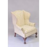 A GOOD MAHOGANY WING ARM CHAIR on cabriole legs ending in claw and ball feet.