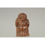 AN AMUSING CARVED WOOD BEAR FIGURE NETSUKE. Signed.