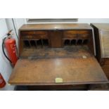 A GEORGE III OAK BUREAU with fall front over four long graduated drawers. 3ft 2ins wide.