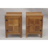 ROBERT "MOUSEMAN" THOMPSON. AN PAIR OF OAK BEDSIDE CUPBOARDS each with an adzed rectangular top,