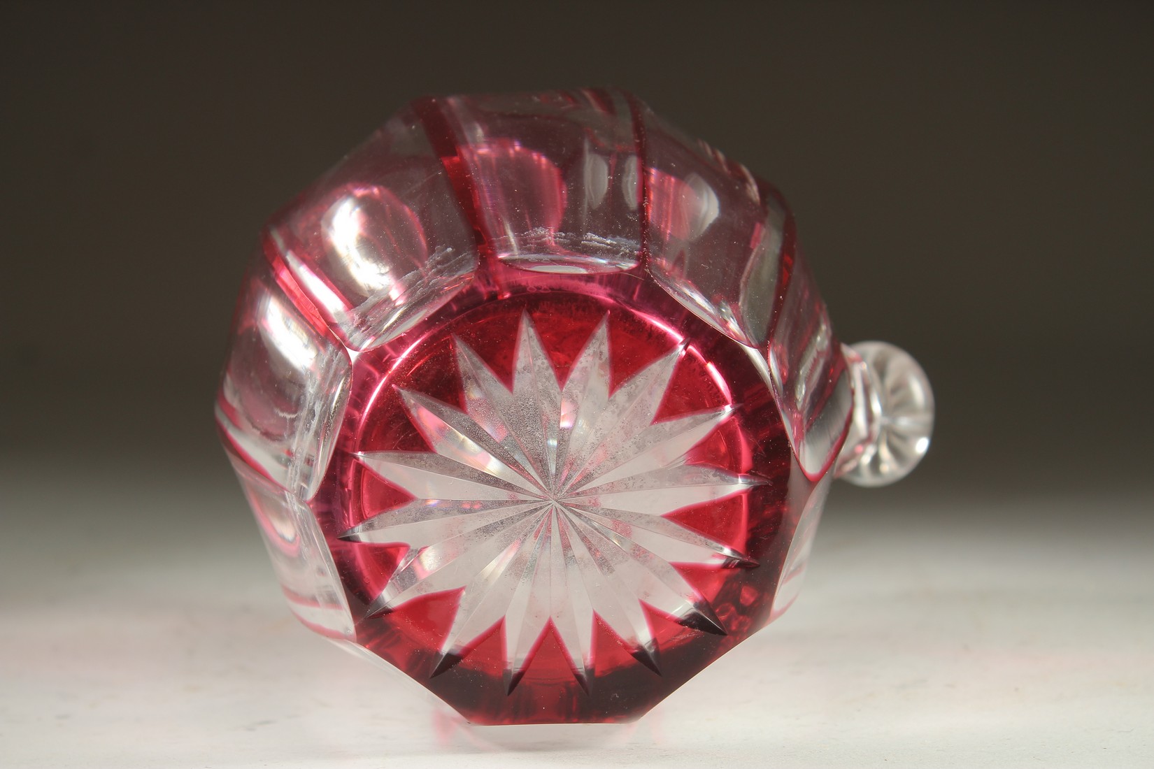 A SLICE CUT RUBY TINTED GLASS EWER with stopper. 7ins high. - Image 5 of 5