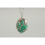 A SILVER AND GREEN ENAMEL LILY OF THE VALLEY LOCKET AND CHAIN.