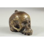 A RARE POSSIBLY 17TH CENTURY DUTCH BRASS POMANDER formed as a skull with fitted up lid. 2.5ins long,