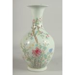 A CHINESE BULBOUS VASE painted with flowers and birds in famille rose. Six character mark in blue.