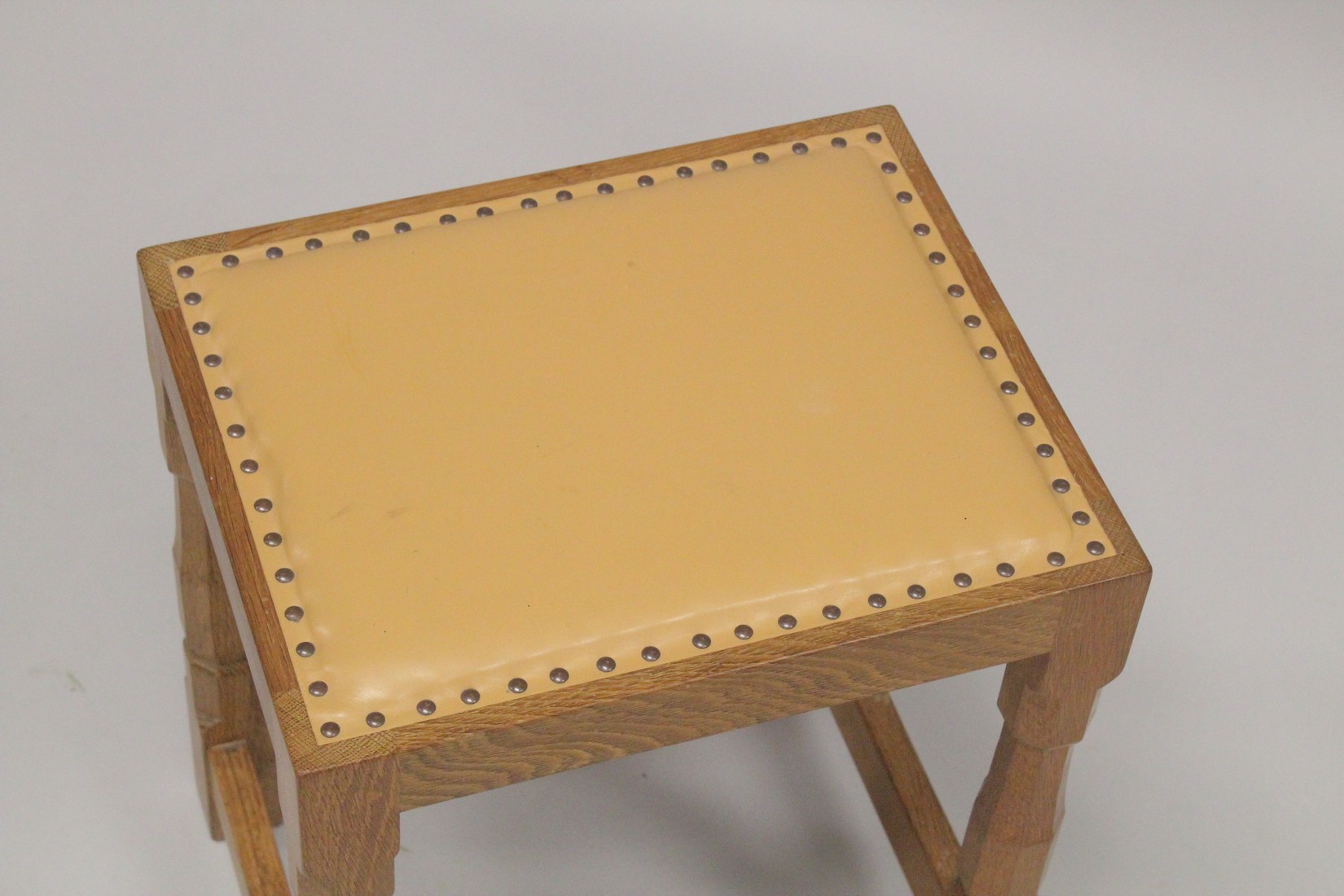 ROBERT "MOUSEMAN" THOMPSON. AN OAK STOOL with close nailed tan leather seat, on four stretchered - Image 2 of 3