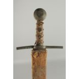 A GERMAN SWORD in a leather scabbard with brass handle. Inventory No. 10.1300. 39ns long.