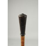 A RHINO HORN HANDLED CANE with a turned handle and segmented horn shaft.