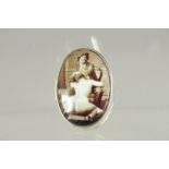 A STERLING SILVER OVAL PILL BOX the lid with a nude. 1.25ins x 1in.