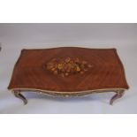 A LOUIS XVITH STYLE MAHOGANY INLAID COFFEE TABLE with floral crossbanded legs on curving legs. 4ft