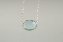 AN AQUAMARINE SILVER PENDANT AND CHAIN.