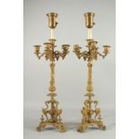 A GOOD PAIR OF BRONZE CANDLESTICKS with four scrolling branches. 28ins high.