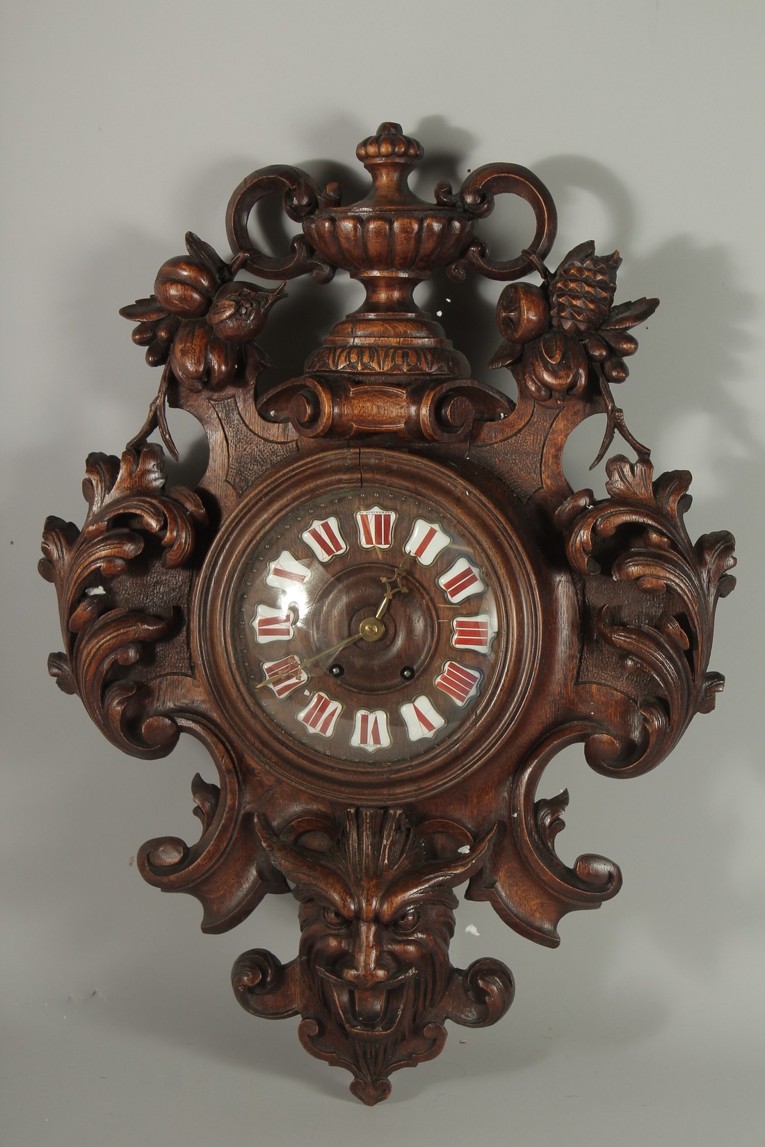 A LARGE CARVED WOOD CLOCK with urns and acanthus scrolls. 28ins high.