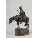 A SUPERB 19TH CENTURY RUSSIAN BRONZE "A COSSACK" holding gun, on a base. 11ins high.